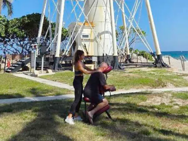 GypSea Breeze outdoor chair massage with the Hillsboro Lighthouse and ocean behind it