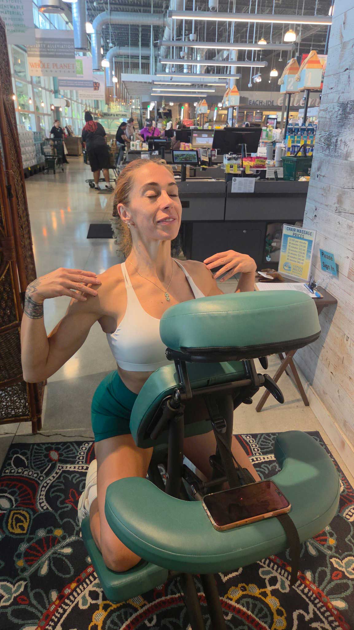 Guest enjoying a GypSea Breeze chair massage at a workplace wellness event